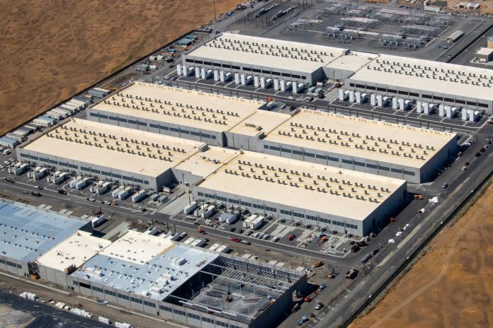 FERC Approves PJM Data Center Registry, Rejects Plan to Curtail Server Farms' Power Aerial view of a large data center campus with rows of server buildings and nearby electrical substation