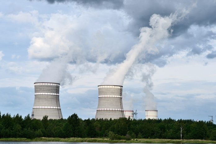 Amazon Nuclear Power Play: Funding and Buying From a 960 MW Indiana SMR Plant Cooling towers of a nuclear power plant against a blue sky