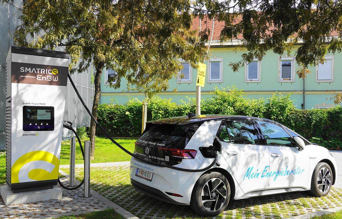 Electric vehicle plugged into a fast-charging station