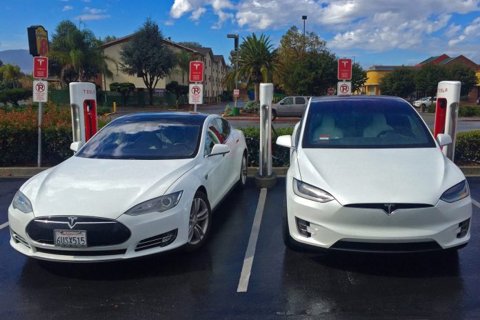 n02-hero Two Tesla electric cars charging at a Supercharger station in Gilroy, California.