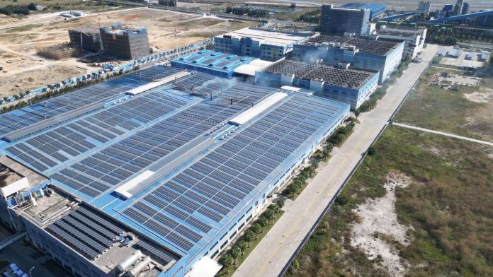 China Solar Export Controls Put 30% Tandem Manufacturing Under Lock — What US Solar Factories Face in 2026 Aerial view of a large industrial complex with solar panels covering its rooftops