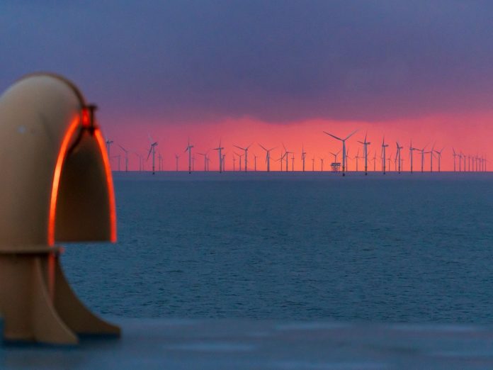 Hornsea 3 Offshore Wind Transmission Tender: Ofgem Launches Record £3.5B Round Offshore wind turbines with a converter platform in the North Sea at dawn